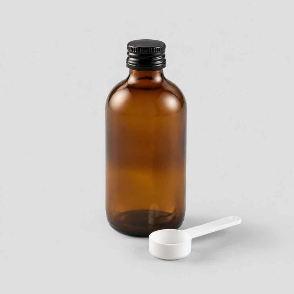 Flacon en verre teinté de 250 ml d'huile de poisson oméga 3 avec sa cuillère-mesure